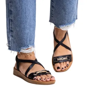 Black sandals with a gold buckle by Pamphila